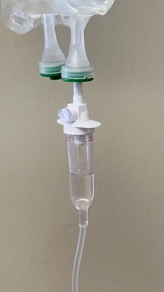 Close-up of an IV fluid bag and drip chamber